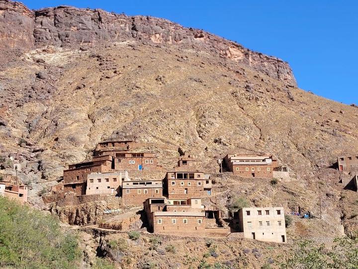A Berber village built into a red hillside in the High Atlas
