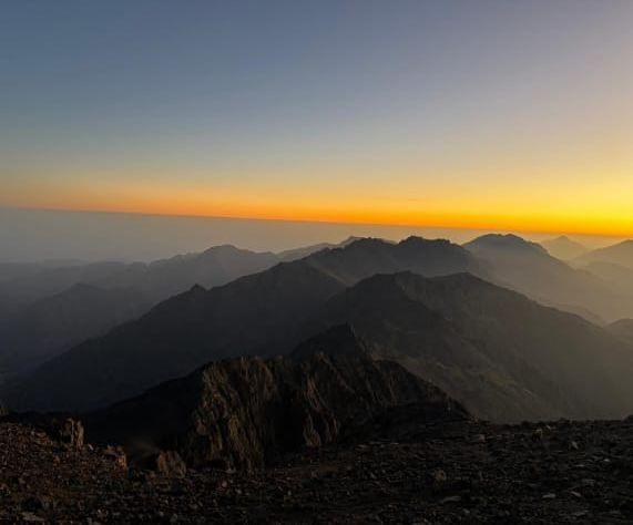 Layers of mountain ridges at sunrise seen from a high summit